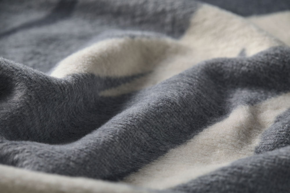 SAVONA throw "skis & tracks" in . Throw Blanket made by David Fussenegger , a family-run mill in Austria.