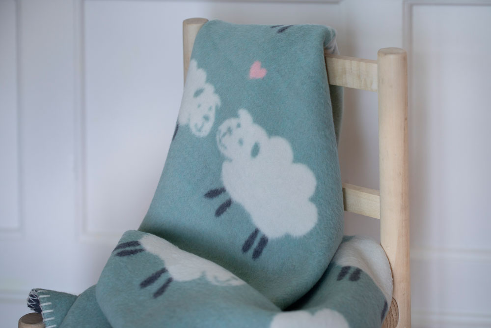 MILA baby blanket "sheep allover" in . Blanket made by David Fussenegger , a family-run mill in Austria.