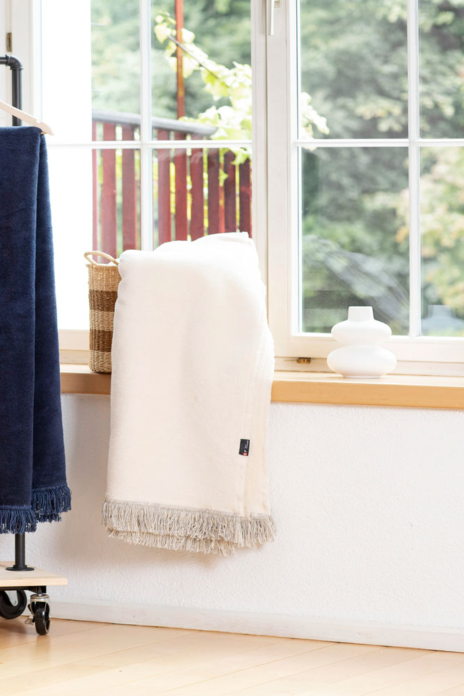 VIENNA throw solid with fringe in . Throw Blanket made by David Fussenegger , a family-run mill in Austria.