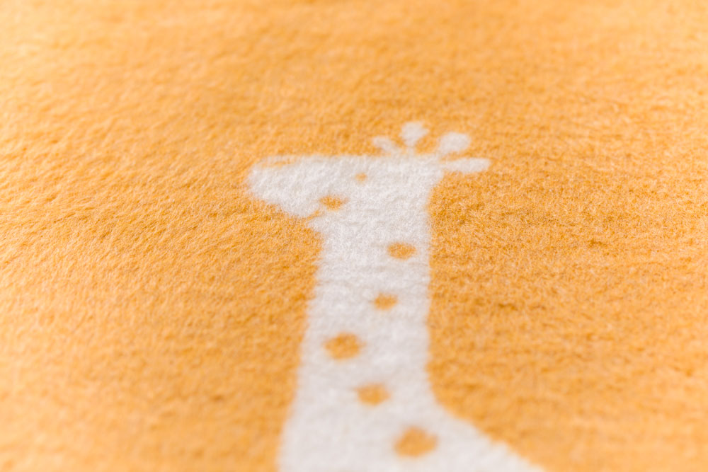 MILA kid blanket "giraffes allover" in . Blanket made by David Fussenegger , a family-run mill in Austria.