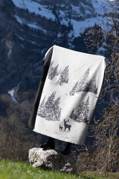 SAVONA throw "snowy trees/stag" in . Throw Blanket made by David Fussenegger , a family-run mill in Austria.