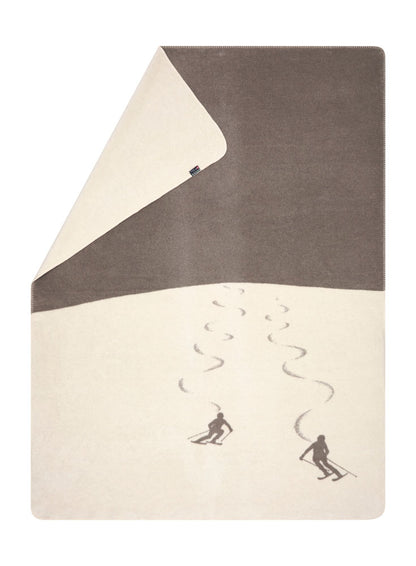 SAVONA throw "skiers leaving tracks" in smoke . Throw Blanket made by David Fussenegger , a family-run mill in Austria.