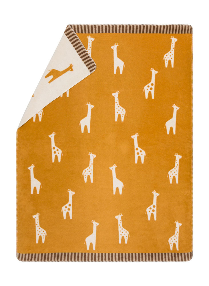 MILA kid blanket "giraffes allover" in gold . Blanket made by David Fussenegger , a family-run mill in Austria.
