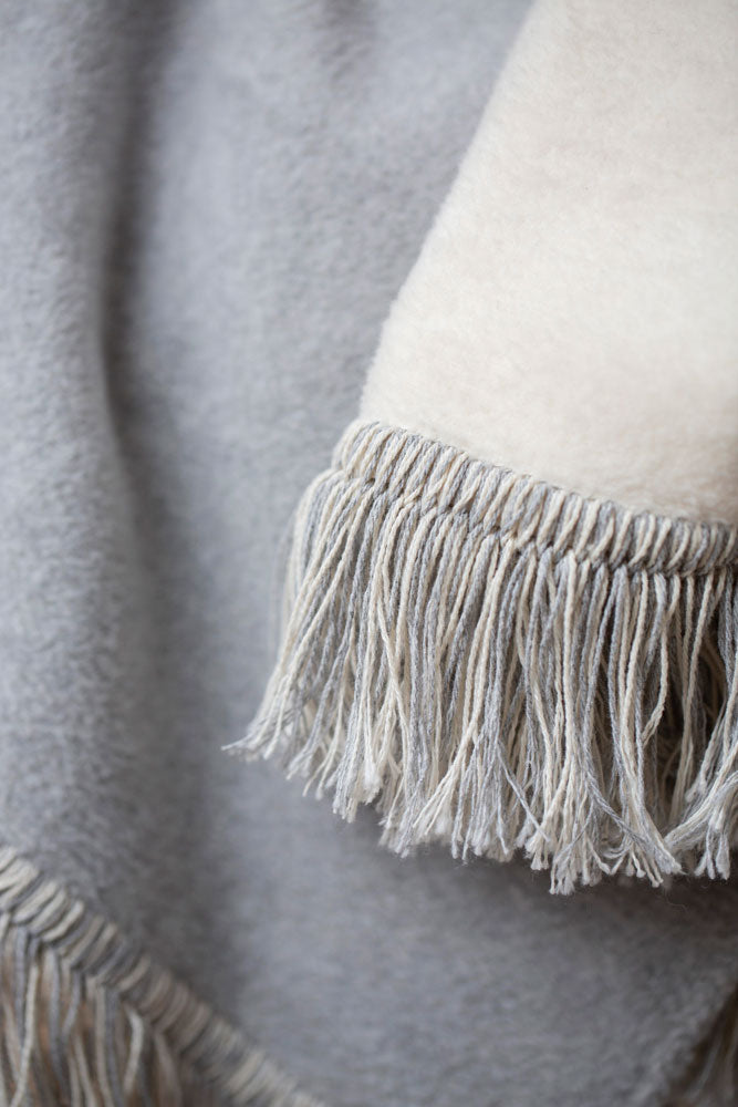 VIENNA throw solid with fringe in . Throw Blanket made by David Fussenegger , a family-run mill in Austria.