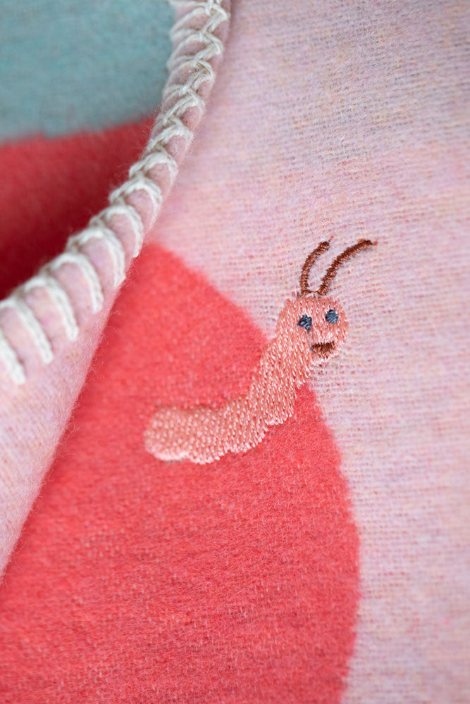 LILI baby blanket "cherries with worm" with embroidery in . Blanket made by David Fussenegger , a family-run mill in Austria.