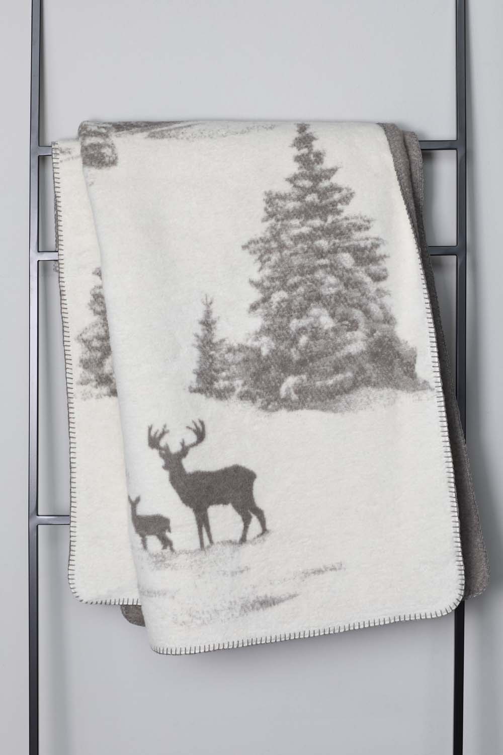SAVONA throw "snowy trees/stag" in . Throw Blanket made by David Fussenegger , a family-run mill in Austria.