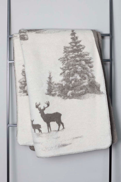 SAVONA throw "snowy trees/stag" in . Throw Blanket made by David Fussenegger , a family-run mill in Austria.