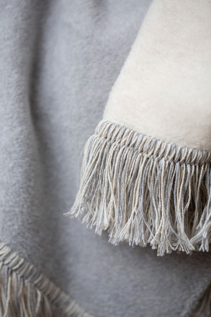 VIENNA throw solid with fringe in . Throw Blanket made by David Fussenegger , a family-run mill in Austria.